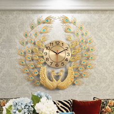 a gold clock with peacocks on it in a living room next to a couch