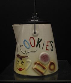 a ceramic tea pot with the words cookies on it