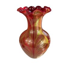 a red and yellow glass vase sitting on top of a table