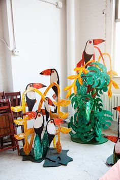 several colorful sculptures are on display in a room