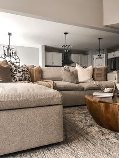 a living room filled with lots of furniture and pillows on top of a wooden table