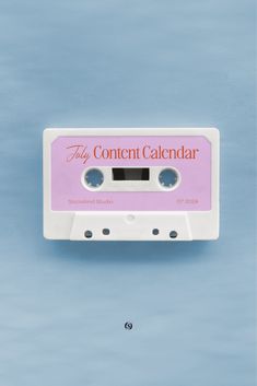 a pink and white cassette with the word tiny content calendar on it's side