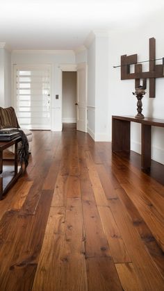 a living room with hard wood floors and white walls