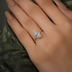 a woman's hand with a diamond ring on it