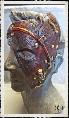 This unique and fully handmade mask is made of 6-7 oz veg tanned leather dyed with a warm dark-brown and treated with a leather satin acrylic finisher. The mask is decorated with punched gears, as well as alchemical symbols. In addition, brass springs, vial, gears and plastic tubes add both alchemical and steampunk notes to this creation. A sturdy, soft leather strap with a roller buckle allows you to adjust the mask around your head. If you have any questions or would like a custom creation in this style, do not hesitate to contact me. Please take a look at my other items and be sure to add me to your favorites list as I often add new creations in my shop! Alchemical Symbols, Alchemic Symbols, Handmade Mask, Half Mask, Costume Masks, Leather Mask, Leather Dye, Costume Mask, Veg Tan Leather