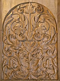 an intricate carved wooden door with floral designs on it's face and bottom panel