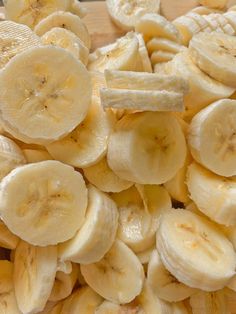 sliced bananas are sitting on a cutting board