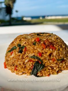 a white plate topped with rice and vegetables