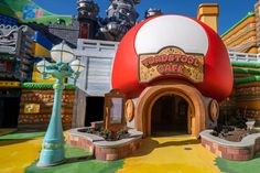 the entrance to an amusement park that looks like a mushroom house