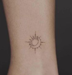 a small sun and moon tattoo on the side of a woman's foot,