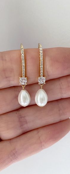 Our pearl drop bridal earrings are simply stunning! A simple classic earring. Little bit of bling, classic pearl, small drop... perfect combo! These long pearl drop earrings catch the light, packing serious sparkle for their size. Combining marquise crystals stones they're finished with glowing pearls. With just the right amount of sparkle, this dainty pair is perfect for brides, mother of the bride and bridesmaids alike. -Drop Pearls are light ivory- These Crystal and pearl wedding earrings will add a flawless finish to every bridal look. ** Delivery is 3 Weeks ** SHOP MORE STYLES https://www.etsy.com/ie/shop/BridalStar?ref=related&listing_id=768478002# *RETURNS- We accept returns . ** Bridal Jewelry Pearl Earrings, Diamond And Pearl Earrings, Brides Mother, Bridal Jewelry Pearl, Elegant Pearl Jewelry, Jewelry Pearl Earrings, Gold Bridesmaid Jewelry, Bridal Drop Earrings, Gold Bridal Jewelry