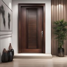 a wooden door in a white room with two vases on the floor next to it