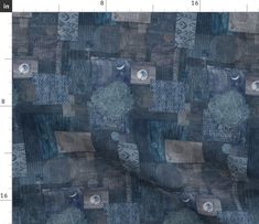 a blue and gray patchwork fabric with different designs on it, as well as numbers