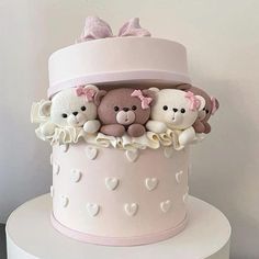 there is a pink cake with teddy bears on it