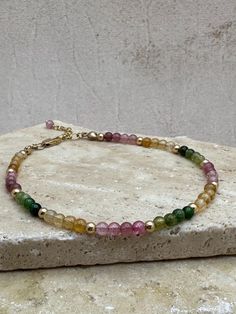 Multicolored Tourmaline Bracelet - Delicate Gemstone Bracelet, Genuine Tourmaline Bracelet, Gold Tourmaline Bracelet, Sterling Silver, Rose, Good Energy Bracelet, October Birthstone. For this beautiful tourmaline bracelet, I've chosen multicolored rounds in pink, green, yellow and blue colors 3.5-4mm accented with tiny spacers beads. Your choice of magnetic or lobster trigger clasp, trigger clasp will have a 1' extender.  *All components are made with either sterling silver or gold filled and ge Pink Green Yellow, Tourmaline Bracelet, Energy Bracelets, Bracelet Sterling Silver, October Birthstone, Yellow And Blue, Good Energy, Bracelet Gold, October Birth Stone