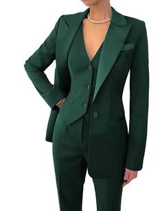 a woman wearing a green suit and pearls