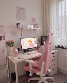 a pink chair sitting in front of a computer desk