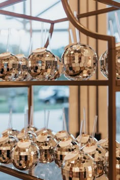 many shiny glass balls on a metal rack