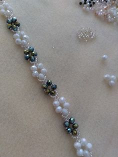 the necklace is adorned with pearls and beads