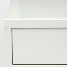 a close up of a white drawer with no drawers on the bottom and one drawer open