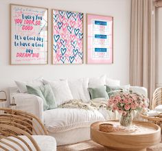 a living room with wicker furniture and paintings on the wall above it's couch