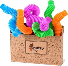 a box filled with assorted colorful plastic hair clips in front of a white background