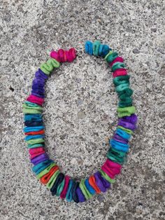 a multicolored bracelet is laying on the ground