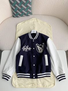 Embrace a sophisticated take on varsity style with this LV-inspired Calfskin Navy Varsity Jacket. Crafted from a luxurious blend of navy blue wool and supple calfskin leather, this jacket exudes timeless elegance. The contrasting white sleeves and ribbed detailing add a sporty touch, while the meticulously embroidered Louis Vuitton-inspired script and graphic on the chest elevate the design. This versatile jacket is perfect for layering and adding a touch of luxury to any casual ensemble. Louis Vuitton College Jacket, Navy Varsity Jacket, Lv Inspired, White Sleeves, Fall Winter Jacket, Drew Starkey, Edgy Accessories, Versatile Jacket, Varsity Style