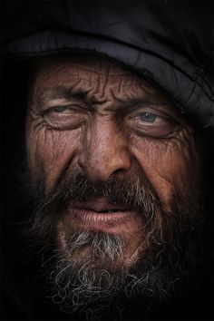 an old man with a beard wearing a hat