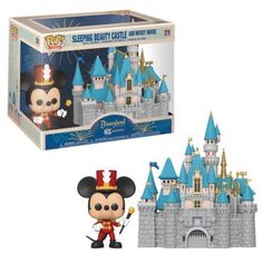 the disney castle with mickey mouse figurine and pop vinyl figure is in its box