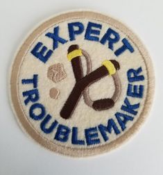 an embroidered patch with the words expert roublemmarker on it