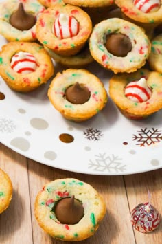 some cookies with candy on them and one has a bite taken out of the middle