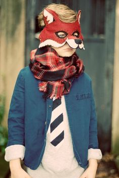 a young boy wearing a red fox mask