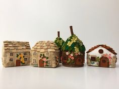 five small houses made out of clay with flowers on them