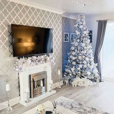 a living room decorated for christmas with a large tv