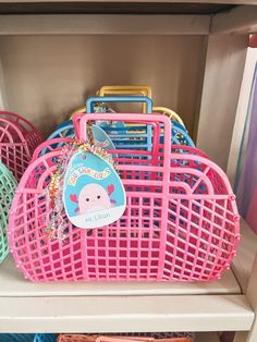 pink and blue baskets are sitting on the shelves in a toy closet with other toys