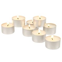 six white candles are lined up in a row