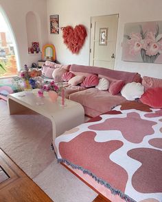 a living room filled with lots of pink furniture