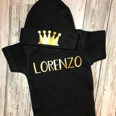 "Personalized name baby boy outfit shown in black and gold! So sweet and simple! Makes a great baby shower gift or coming home outfit for your new little prince!  💜 COLORS: Colors will automatically come in the colors in the main photo, black & gold. If you would like to change the colors please read below and leave changes in the notes with your order.   💜 BEANIE: Beanie is 0-4 months, with crown. Colors: Red, gray, pink, hot pink, light blue, black, white, green, royal blue, navy, mint, yellow, brown. 💜 FONT COLORS: If you want to change the font color (instead of gold)  Slide photo over for FONT color chart and leave color in the notes with your order.    💜 BODYSUIT: Leave changes in the notes with your order. Leave name EXACTLY how you would like it (capitals and lowercase how you Name Baby Boy, Baby Boy Beanies, Newborn Boy Hats, Prince Crown, Crown Black, Sibling Shirts, Baby Shower Gifts For Boys