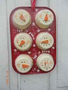 some cupcakes that have been decorated to look like snowmen and carrots