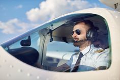 a pilot sitting in the cockpit of an airplane