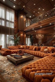 a large living room filled with lots of couches and tables in front of windows