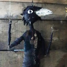 an odd looking puppet is hanging on the wall