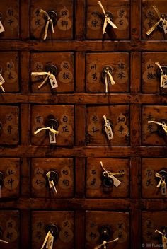 an old wooden drawer with many keys and numbers on it