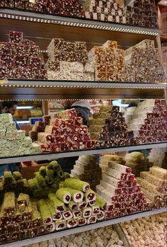 a display case filled with lots of different types of sweets and candies for sale