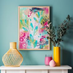 a painting on the wall next to vases and flowers