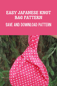 a pink and white polka dot bag hanging from a tree