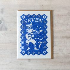 a blue and white greeting card with an image of a cat playing the guitar on it