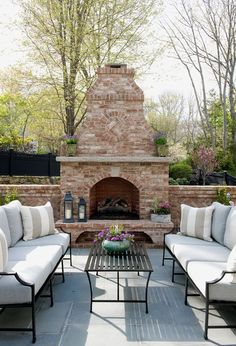 an outdoor fire place for patio is displayed on the webpage, which displays it's own fireplace and seating area