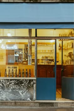 a store front with bottles on display in the window